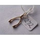 A small 9ct wishbone charm