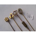Four various stone set gold topped stick pins