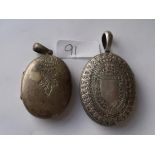 A large vintage oval silver locket and a metal one