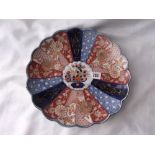 An Imari saucer dish with shaped edge 12” dia