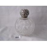 Large spherical cut glass scent bottle with embossed l lift off cover. 4” dia