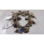 Silver charm bracelet set with many different charms 57g