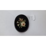 An oval micro mosaic plaque depicting a bird and flowers.