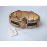 An unusual gilt stone set panel bracelet