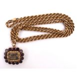 George IV garnet set gilt mourning brooch on 9ct gold chain. An oval brooch the surrounded by