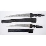 Pair of North African swords. A long-sword and short-sword in tooled leather scabbards. Length of