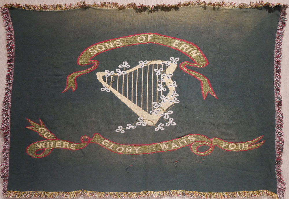 Sons of Eireann banner. A large green banner, centred with a shamrock-entwined harp, ribbons above