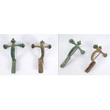 Two late-Roman bronze crossbow toga pins. Two bronze crossbow fibula of a type used by