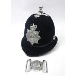 Polini Ath Cliath belt buckle and a police helmet. The white metal two piece buckle centred with the