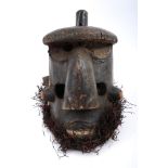 Tribal mask, Bushongo, Central Congo. A large carved helmet-shaped dancing mask, with grass beard.
