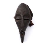 Tribal mask, Songye, Congo. Of elongated form with protruding, lozenge-shaped lips, incised cross-