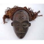 Tribal mask, Jokwe, Central Congo. A carved wood mask, the features finely rendered, with almond-