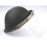 Circa 1970 Northern Ireland, British Army steel helmet with visor. A British Mk IV steel helmet,