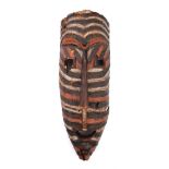 Tribal mask, Songye, Congo. A painted, chip-carved wooden mask, the narrow, elongated face with