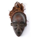 Tribal mask, Jokwe, Central Congo. A carved wood dancing mask, the features finely rendered, with