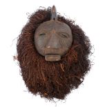 Tribal mask, Kuba, Congo. A large carved wood, lion mask with grass 'mane'. 13in. (33cm) Collected