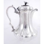 A William IV Irish silver water jug, by Richard Sawyer, jr. The flower-shaped finial on moulded,