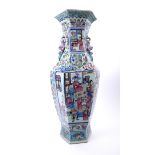 A famille rose hexagonal vase. A porcelain vase, the baluster-shape body painted with court scenes