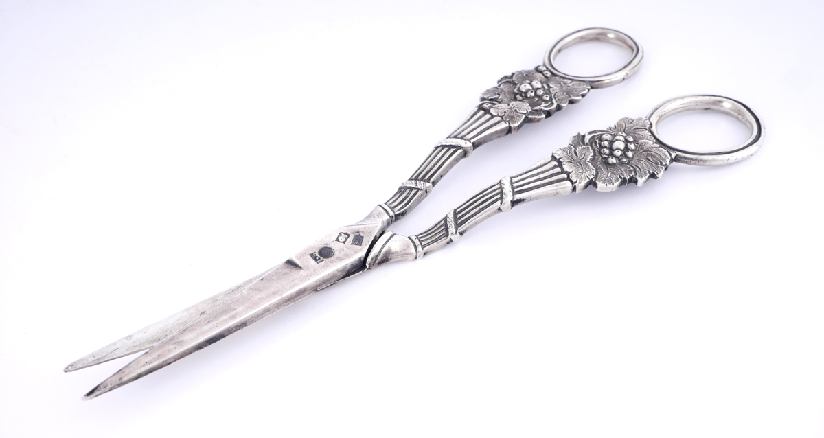 A pair of George III Irish silver grape scissors. The rings mounted to bunches of grapes and