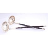 A pair of Victorian Irish silver toddy ladles. The plain oval bowl on twisted wood handle with