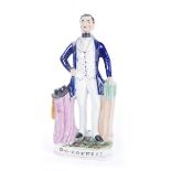 19th century Staffordshire figure of Daniel O'Connell. The moulded figure standing in a blue coat,