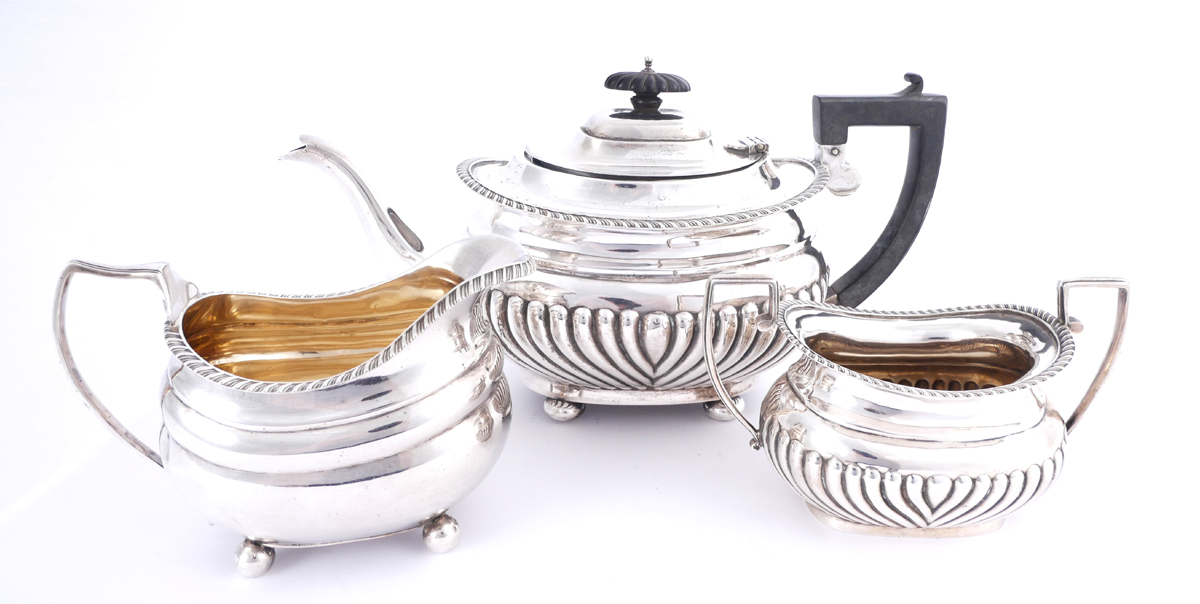 A three-piece silver harlequin tea service. The teapot, Chester, 1911; the sugar bowl, Birmingham,