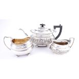 A three-piece silver harlequin tea service. The teapot, Chester, 1911; the sugar bowl, Birmingham,