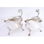 A pair of George II silver sauceboats with Powerscourt crest, by David Hennell. The wavy rim over