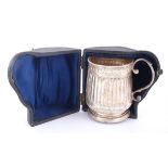 A George II silver mug and a collcetion of later silver wares. The mug with fluted sides, London,