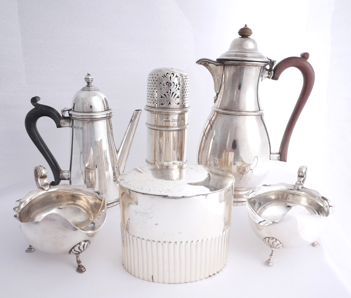 A collection of George V silver wares by Asprey, Mappin and Webb and Adie. A hot water jug,