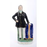 19th century Staffordshire figure of Daniel O'Connell. The moulded figure standing in a black coat