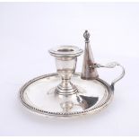 A Victorian silver plated chamber candlestick and snuffer. The sconce on a dished circular base with