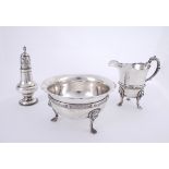 An Irish silver sugar bowl and creamer and an 18th century silver caster. The wavy rim over plain