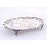 A George III Irish silver teapot stand. The oval reserve with moulded rim on four feet. Dublin,