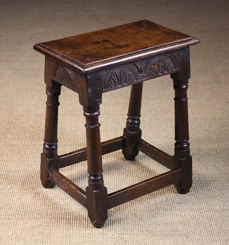 A Good 17th Century Oak Joint Stool with lunette carved rails and astrigal ringed legs united by