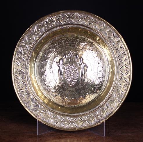 A 17th Century Repoussé Brass Alms Dish intricately decorated with 'The Spies of Canaan' to the