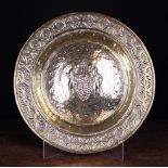 A 17th Century Repoussé Brass Alms Dish intricately decorated with 'The Spies of Canaan' to the