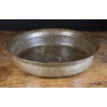 A Large 17th Century Bronze Bowl with ring turning encircling a small central boss,