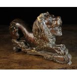 An 18th Century Carved Walnut Heraldic Lion Couchant, 9 in (23 cm) high, 13 in (33 cm) in length.