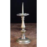 A 17th Century Bronze Pricket Candlestick with an acorn knopped baluster stem and turned foot,