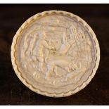 An Ivory Game Counter carved with a hunting scene, 16th Century, 6 cm in diameter.