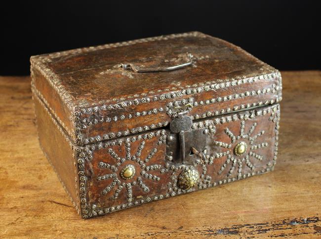 A Fine Late 17th Century Leather Clad Casket embellished with decorative brass studs.