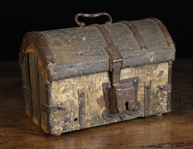 A 17th Century Oak & Iron Bound Dome-topped Casket with residual cuir bouilli cladding.