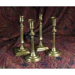Two Pairs of George III Brass Candlesticks: One being a near pair having square fluted columns with
