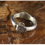 A Silver-coloured 'Fede' Ring with clasped hands to one side and a quatrefoil flower to the other,