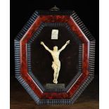 An Antique Flemish Carved Ivory Corpus Christi mounted on a padded velvet board above a plaque