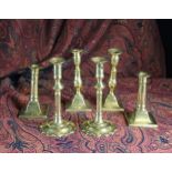 Three Pairs of 18th Century Brass Candlesticks; one pair with petalled bases 8 in (20 cm) in height,