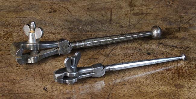 Two Antique Steel Hand Vices with wing nut fasteners, 5½ in (14 cm) and 4¾ in (12 cm) in length.