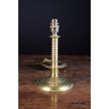 A Brass Table Lamp converted from a trumpet based candlestick with ribbed stem and drip pan,