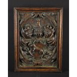 An Oak Armorial Panel having an oval cartouche relief carved with an animal surmounted by a pig in